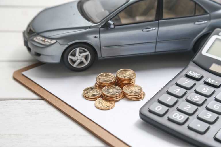 car model calculator and coins on white table