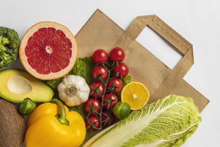 flat lay of assortment of vegetables with paper bag