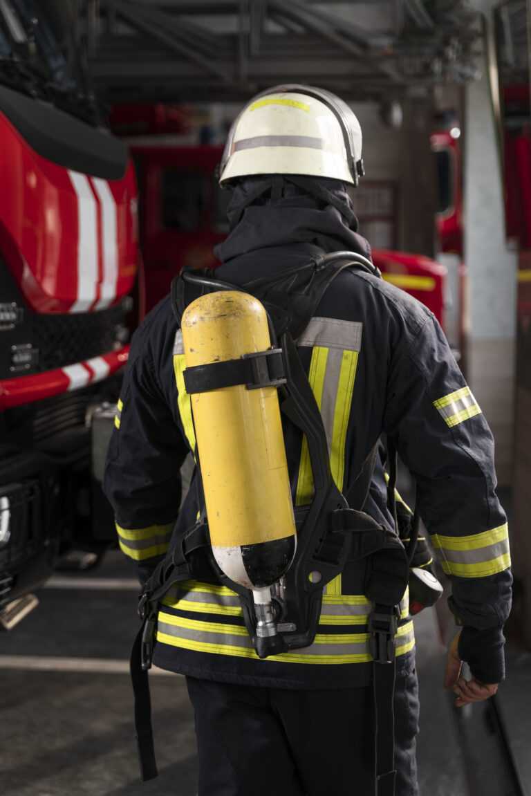 firefighter at the station with suit and safety helmet
