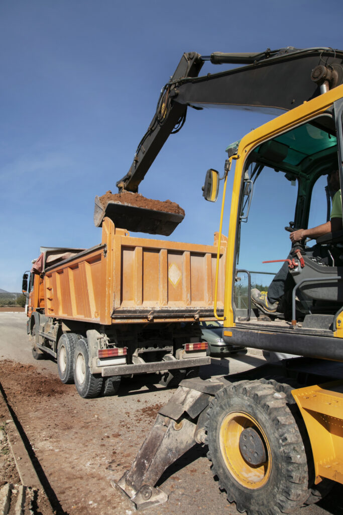 excavator digging ground day light